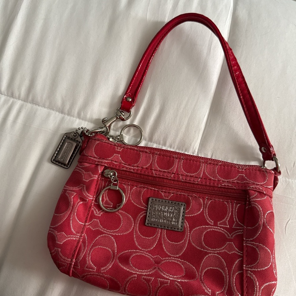 pink coach shoulder bag with silver detailing